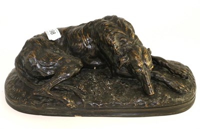 Lot 198 - After Paul Joseph Raymond Gayrard (1807-55), a bronze model of a recumbent deer hound, bears...