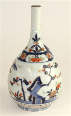 Lot 213 - Imari porcelain bottle vase 18th century, painted with bamboo, prunus and papaya, 32cm high