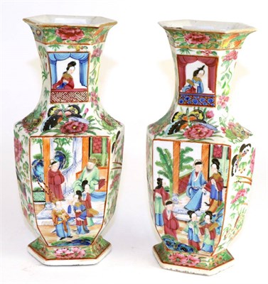 Lot 214 - A pair of Cantonese hexagonal baluster vases, 19th century, painted in famille rose enamels...