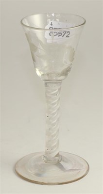 Lot 232 - A wine glass, circa 1750, the rounded final ball engraved with flowers on an opaque twist stem...