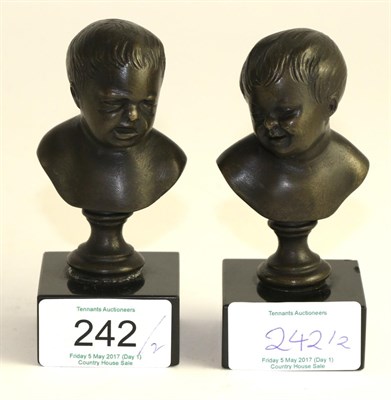 Lot 242 - A pair of bronze busts of children after Roubillac, on circular pedestals and black marble...