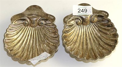 Lot 249 - A matched pair of late Victorian silver butter shells, London 1895 and 1900, 13cm long