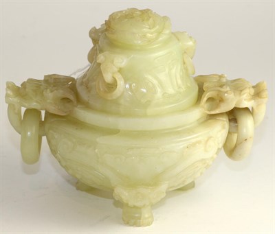 Lot 252 - A Chinese carved jade vase and cover with handles in the form of dogs of foe, with loop...