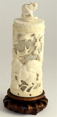 Lot 255 - A Japanese ivory tusk vase and cover, Meiji period, pierced with tigers attacking an elephant...