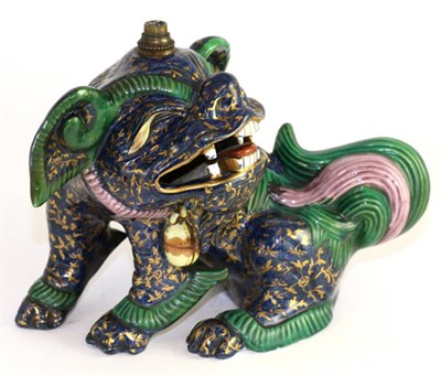 Lot 273 - A Chinese porcelain lion dog seated, decorated in blue, green and gilt, 19cm high, converted to...