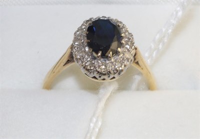 Lot 291 - A sapphire and diamond cluster ring, an oval cut sapphire within a border of eight-cut diamonds...