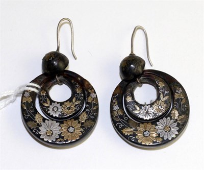 Lot 295 - A pair of tortoiseshell and pique work earrings, a domed stud suspends two discs, decorated...