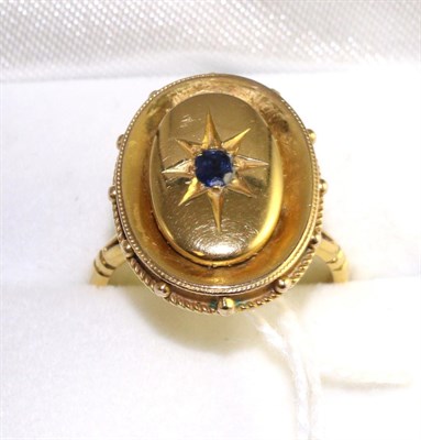 Lot 298 - A sapphire plaque ring, an oval cut sapphire in a yellow star setting, to an oval plaque with a...