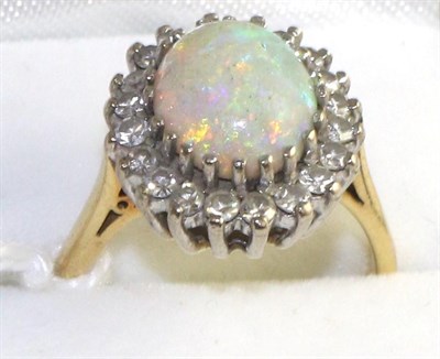 Lot 299 - An opal and diamond cluster ring, an oval cabochon opal within a border of eight-cut diamonds...