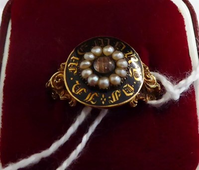 Lot 305 - A Georgian black enamel and pearl mourning ring, a circular top with a central glazed locket...