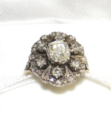 Lot 315 - A diamond cluster ring, set with rose cut diamonds in white claw settings, on a yellow engraved...