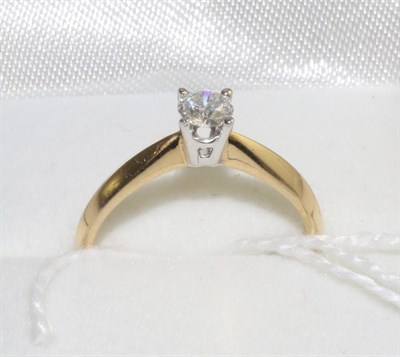 Lot 324 - An 18 carat gold diamond solitaire ring, a round brilliant cut diamond in a white four claw...