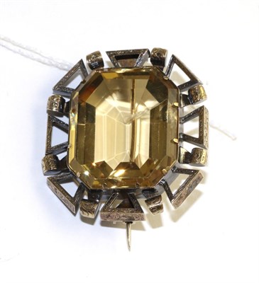 Lot 334 - A Citrine brooch, an emerald-cut citrine in a yellow claw setting and within a fancy pierced...