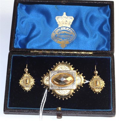 Lot 339 - A cased Victorian brooch and earrings suite, of quatrefoil form with beaded detail, the brooch with