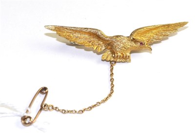 Lot 362 - An eagle brooch, modelled with spread wings and a ruby cabochon eye, measures 5.2cm long