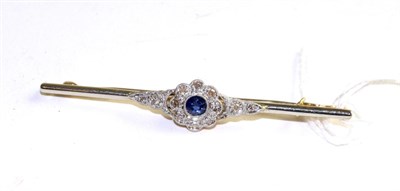 Lot 365 - A sapphire and diamond bar brooch, a round cut sapphire within a border of eight-cut diamonds...