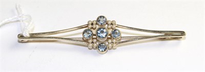 Lot 377 - An aquamarine and seed pearl brooch, four round cut aquamarines in yellow milgrain settings...