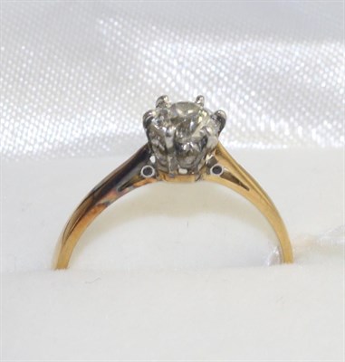 Lot 378 - A solitaire diamond ring, an old cut diamond in a white claw settings to yellow knife edge...