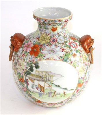 Lot 387 - A Chinese porcelain ovoid vase, Qianlong reign mark but not of the period, with mask and ring...