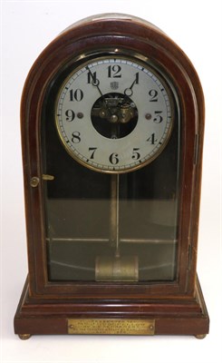 Lot 394 - A Bulle patent electric mantel timepiece, circa 1920, arched case with presentation plaque to base