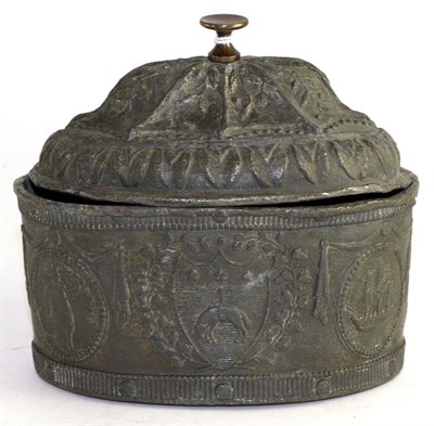 Lot 409 - A 18th century lead tobacco box and cover, cast with crests from roundels, 15.5cm wide