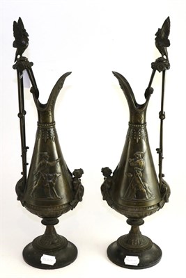 Lot 412 - A pair of late 19th century bronzed ewers decorated with figures and greyhounds with black...