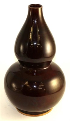 Lot 414 - A Chinese Sang de Boeuf glazed double gourd vase, 39cm high