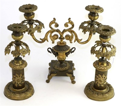 Lot 418 - A late 19th century gilt metal garniture comprising; a two branch candelabrum and a pair of...