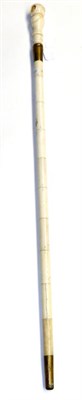 Lot 447 - A bone and marine ivory walking cane, 19th century, the baluster carved handle with a revolving...