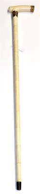 Lot 448 - An ivory and bone walking stick, 19th century, the ferrule and end cap stamped 18ct, 87cm