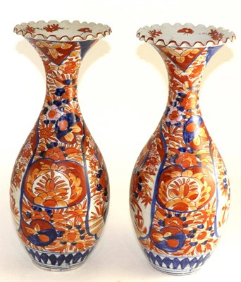 Lot 479 - A pair of Imari porcelain baluster vases, Meiji period, typically painted with foliage, 39cm high