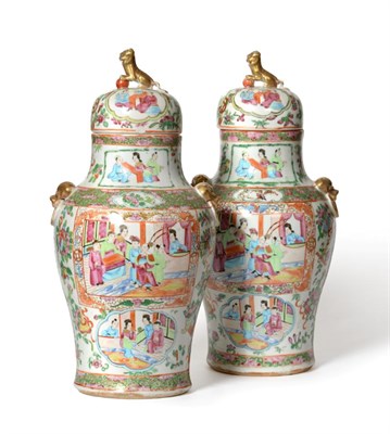 Lot 489 - A pair of Cantonese porcelain vases baluster vases and covers, mid 19th century, with mask and loop