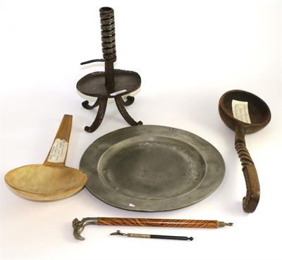 Lot 493 - A pewter plate, a rush light holder, a horn milk skimmer, a carved spoon and a small parasol handle