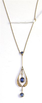 Lot 511 - An Art Nouveau sapphire and seed pearl pendant, a round cut sapphire in a yellow milgrain...