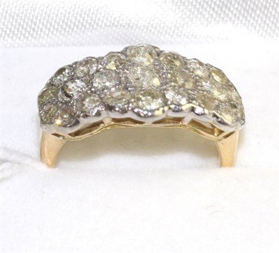 Lot 514 - A diamond triple cluster ring, pavé set with old cut diamonds to yellow tapering shoulders on...