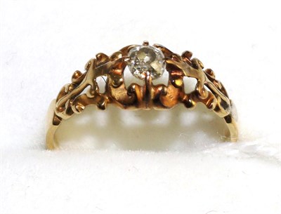 Lot 515 - A diamond solitaire ring, an old cut diamond in a yellow claw setting to pierced scroll...