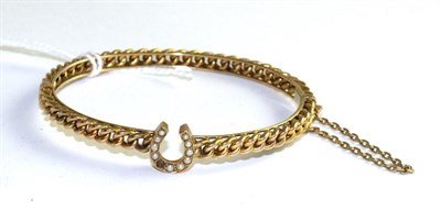 Lot 518 - A seed pearl set bangle, a central horseshoe set with seed pearls to a curb link hinge opening...