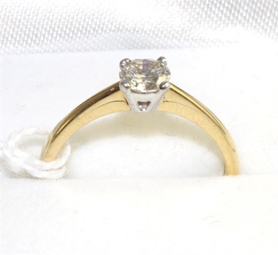 Lot 521 - An 18 carat gold diamond solitaire ring, a round brilliant cut diamond in a white four claw...