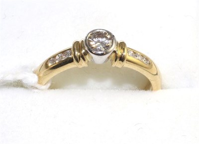 Lot 522 - An 18 carat gold diamond solitaire ring, a round brilliant cut diamond in a white rubbed over...