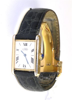 Lot 539 - A silver and plated rectangular wristwatch, signed Cartier, model: Must de Cartier, circa 1990,...