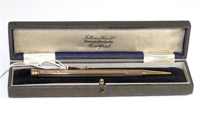 Lot 552 - A 9 carat gold propelling pencil, with engine turned decoration, in a Farttorini & Sons Ltd case