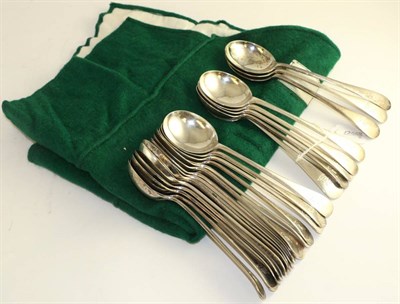 Lot 562 - Twenty four silver soup spoons engraved with a family crest, Sheffield 1922, 58oz