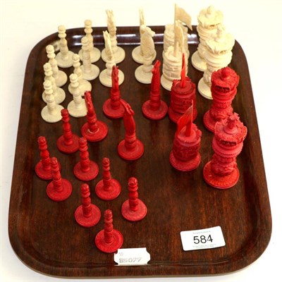 Lot 584 - A stained and natural ivory chess set, late 19th/early 20th century, kings 9cm high