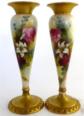 Lot 588 - A pair of Royal Worcester porcelain slender baluster vases, 1914, painted with roses within...