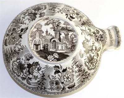 Lot 593 - A pearlware flask, circa 1830, of circular form, printed in black with figures amongst ruins...