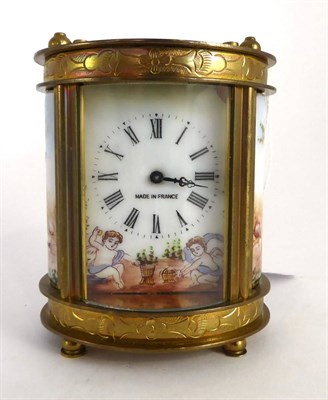 Lot 595 - A brass and porcelain miniature carriage timepiece, 20th century, oval case set with panels...