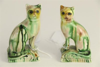 Lot 598 - A pair of Whieldon style pottery figures of seated cats, 9.5cm high