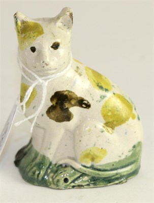 Lot 599 - A Pratt type pottery model of a seated cat, circa 1800, with brown, green and yellow...