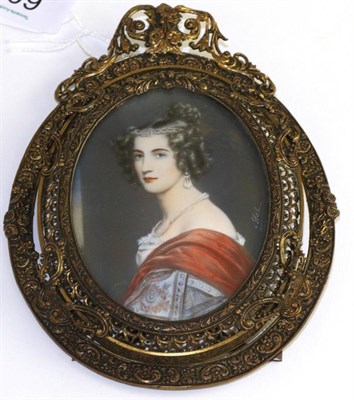 Lot 603 - A portrait miniature of a lady wearing a tiara contained within an elaborate brass frame, 8cm high