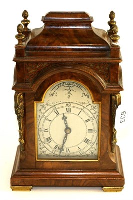 Lot 633 - A walnut veneered mantel timepiece, 20th century, inverted top, glazed side windows, arched...